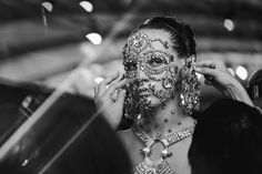 a woman is getting her face painted with jewels and beads in black and white photo