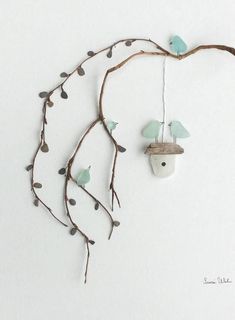 a bird feeder hanging from a tree branch with little birds on it's branches