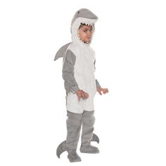 a little boy dressed in a shark costume