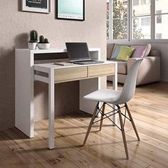 a laptop computer sitting on top of a wooden desk next to a white chair in front of a window