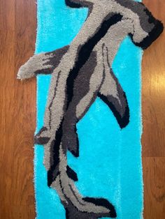 a blue rug with an image of a dolphin on it's back and feet