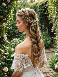 a woman with long hair wearing a wedding dress and flowers in her hair is standing outside