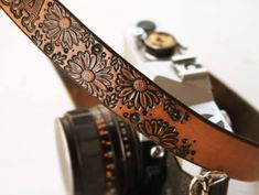 a camera strap with flowers on it