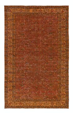 an orange and brown rug with many different patterns on it, including the center border