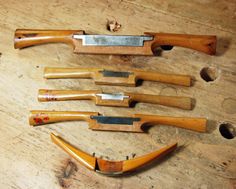 five different types of knives on a wooden table