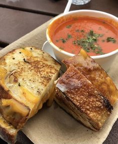 grilled cheese sandwich with tomato soup on the side and bread cut in half to look like sandwiches