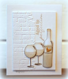 a card with two wine glasses and a bottle