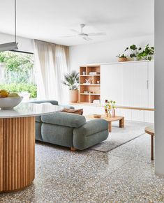 a living room filled with furniture and a bowl of fruit on top of a table