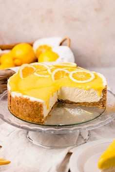 a lemon cheesecake on a glass cake plate