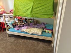 there is a bunk bed with many stuffed animals on it