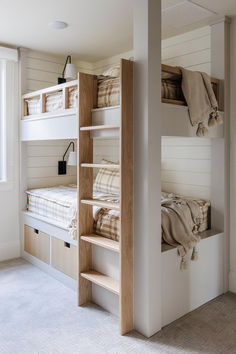 two bunk beds are next to each other in a room with white walls and carpet