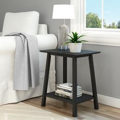 Bring sophisticated style to any room with the Plank+Beam Mid-Century Side Table. Inspired by the clean lines of mid-century design, this modern side table features a sleek design with angled legs and neutral finishes to create a modern look that complements any décor. Durable solid wood construction and non-toxic finishes offer a premium look and exceptional durability. Functional and versatile, this small side table is perfect for us as a bedside table in a bedroom, an end table in the living Bedside Tables Bedroom, Bedside Table Wood, Mid Century Modern Bedside Table, End Tables For Living Room, Side Table For Bedroom, Mid Century Modern End Table, Mid Century Modern Side Table, Mid Century Side Table, Side Tables For Bedroom