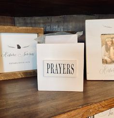 three wooden frames sitting on top of a shelf