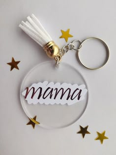 a glass keychain with the word mama written on it and stars around it