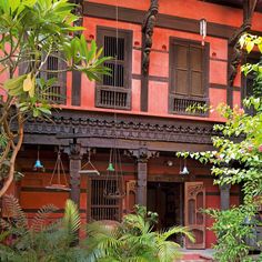 an old building with lots of plants in front of it