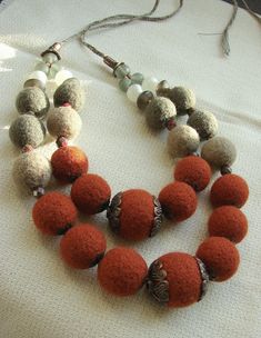 "Unique wool necklace in ethnic style with glass beads. Made to order! Are you looking for a perfect gift for your mum, sister, girlfriend or grandma? This really elegant and aesthetic piece of felted jewelry is an awesome decision! It's very aesthetic and will make your day brighter at the same time. This necklace will be especially in the fall. Its warm colors intersect with the colors of autumn leaves and the sky. All felted balls are handmade from merino wool. The necklace is very light due Felt Ball Jewelry, Felted Balls, Felted Jewelry, Wool Necklace, Felt Necklace, Felt Beads, Felt Jewelry, Ethnic Necklaces, Penny Rugs