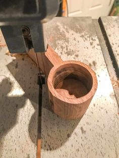 a wooden bowl is being worked on by a machine