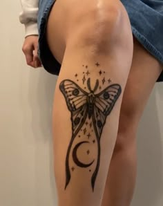 a woman's leg with a butterfly tattoo on it and stars around the legs