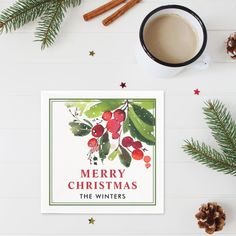 a cup of coffee sitting next to a christmas card