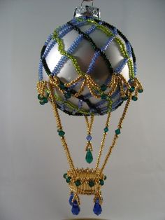 an ornament with beads and chains hanging from it