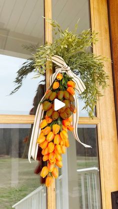 an orange wreath hangs on the front door