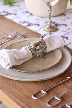 a place setting with silverware and napkins