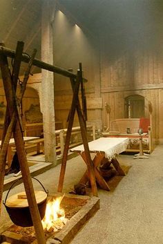 the interior of an old wooden church with benches and fire pit in front of it