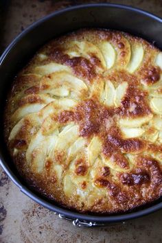 a baked dish in a pan on a counter top with some slices cut out and ready to be eaten