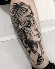 a woman's face with an owl on her head and the other side of her arm