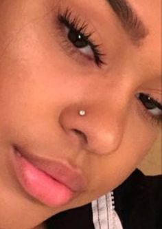 a close up of a person with a nose ring