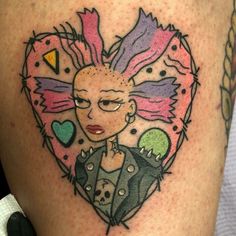 a woman's tattoo with an image of herself in a heart