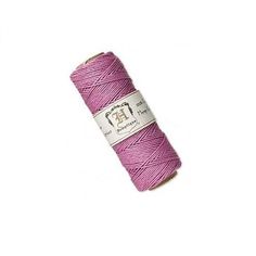 a spool of pink thread on a white background