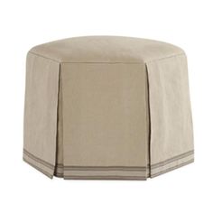 a round ottoman covered with a beige cover