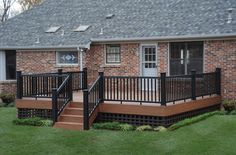 a house with a deck and stairs in the front yard