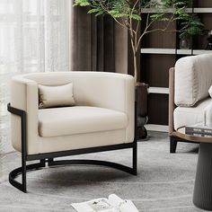 a living room with two white chairs and a tree in the corner on the floor