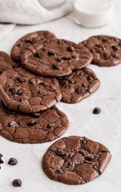 chocolate cookies and milk are on the table