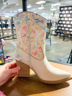 Saddle up in style with our MIA Georgia Western Cowgirl Boots! These cream white boots feature a delicate floral print with intricate stitching, light pink and blue accents, and a sleek pointed toe for a touch of country charm. Designed with a stacked block heel and slip-on closure in vegan leather, they offer comfort with a contoured polyurethane footbed. True to size, they're perfect for pairing with summer dresses or denim shorts for a statement look. Floral Cowgirl Boots, Outfit Cream, Cowboy Girl, Golf Collection, Floral Boots, Light Blue Dresses, Stylish Boots