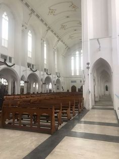 an empty church with pews and stained glass windows