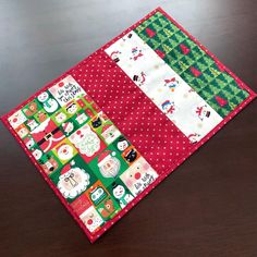 a close up of a piece of cloth on top of a wooden table with christmas decorations