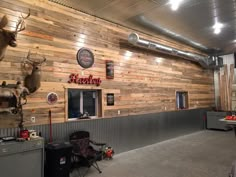 the inside of a restaurant with wooden walls and deer heads on the wall above it