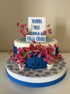 a cake decorated with flowers and a sign