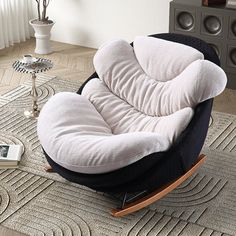 a modern rocking chair in the middle of a living room