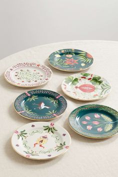 six plates with different designs on them sitting on a table