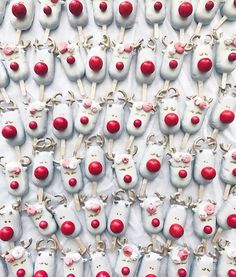 a large group of white and red reindeer heads