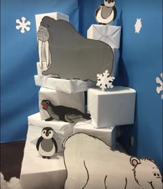 an animal themed birthday cake with penguins and polar bears