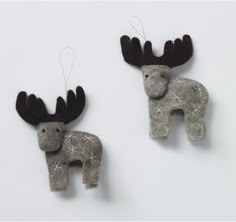 two ornaments made to look like animals with antlers