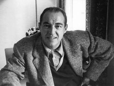 black and white photograph of a man sitting at a table