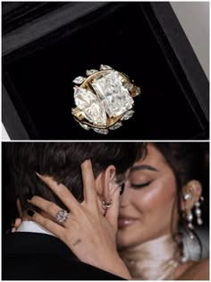 a woman in a black suit and white dress holding a diamond ring on her finger