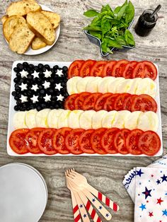 an american flag platter with tomatoes, olives and crackers