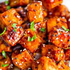 tofu with sesame seeds and garnishes on a plate